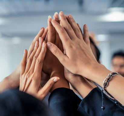 Business people celebrating success with their hands raised in the air.